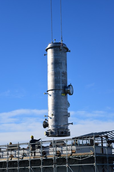The caustic scrubber is nearly 30 feet tall, 6 feet in diameter and weighs 14 tons. Once all the internal components are installed, it will weigh 19 tons. It is one of three major components that make up the offgas treatment system.