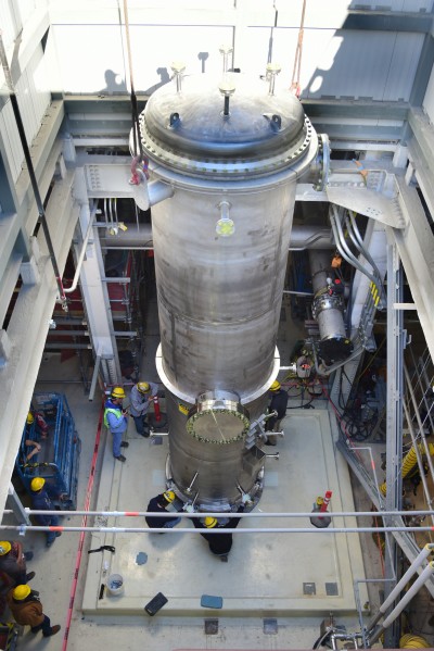 The caustic scrubber was lowered into the LAW Facility by crane through a roof hatch. Vit Plant workers hand-maneuvered the unit into position as the crane operator lowered it from outside the facility.